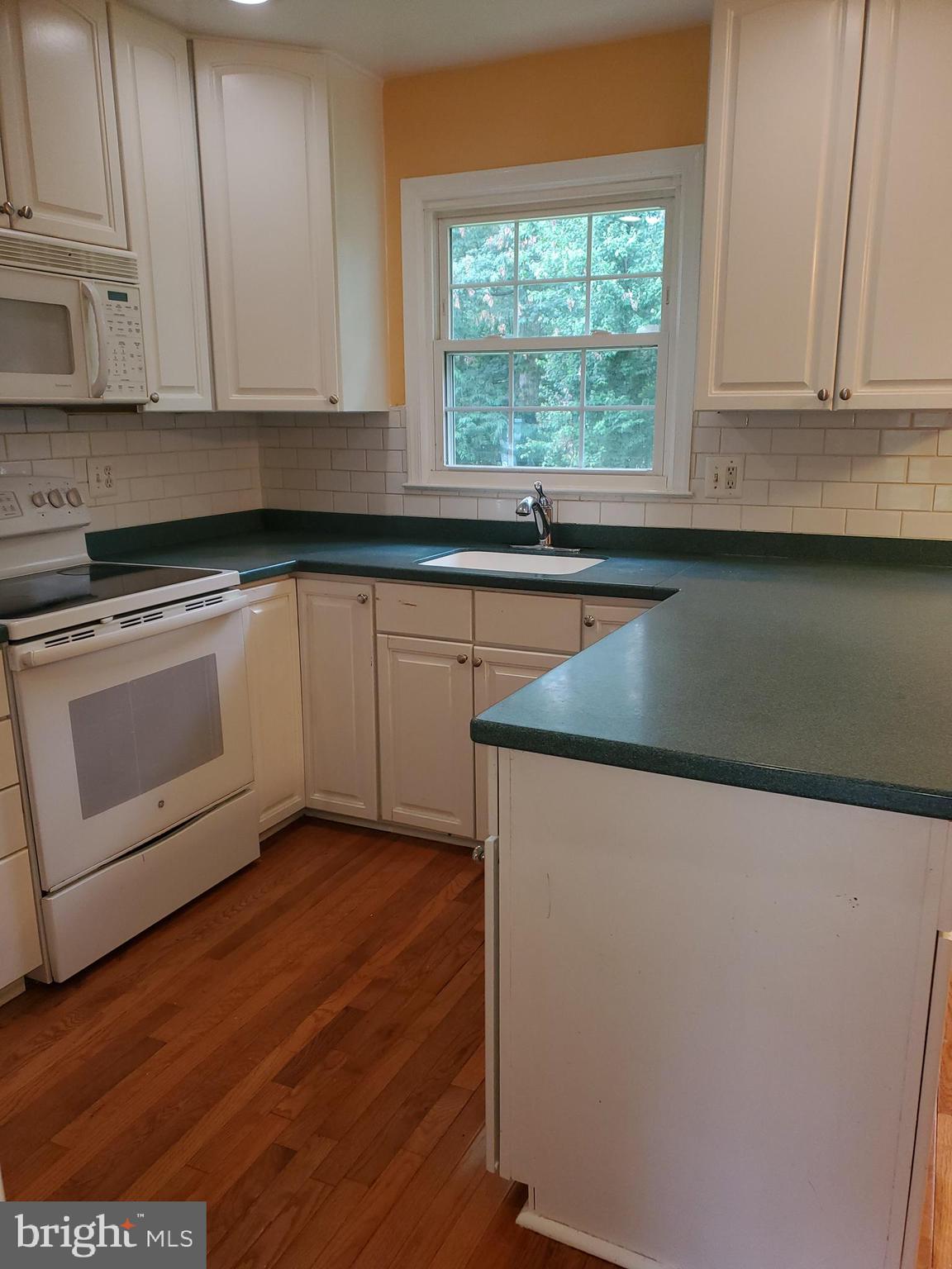 15000 Wellwood Road Silver Spring, MD 20905 - Photo 3 of 26 Kitchen subway tiles and stone counter