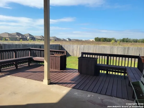 a view of a balcony with wooden floor and outdoor space