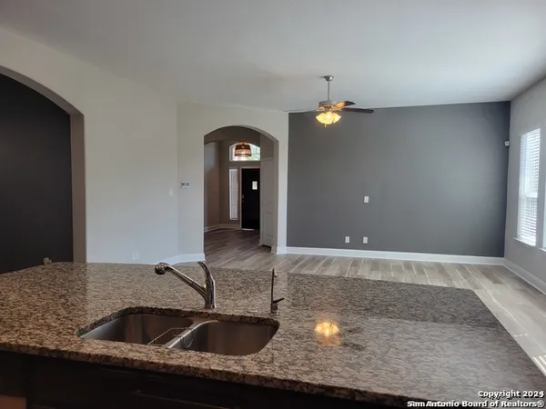 a kitchen with a sink and chandelier