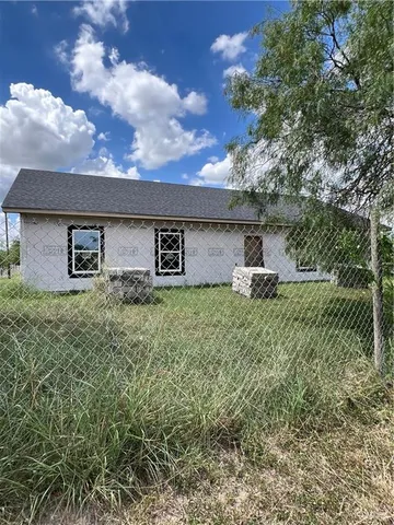 a view of a hallway with wooden floor and entryway