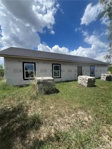 a view of a building with a door and a window