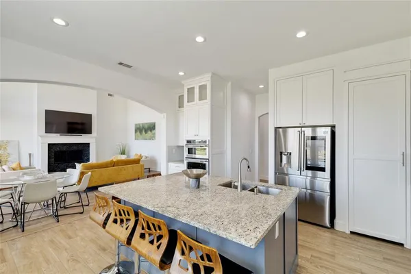a kitchen with stainless steel appliances granite countertop a stove and a refrigerator