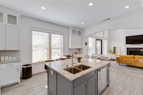 a kitchen that has a sink and a stove in it