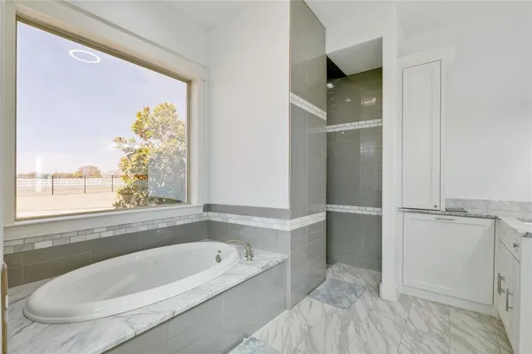 a bathroom with a bathtub and a shower