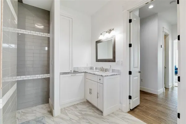 a bathroom with a double vanity sink and mirror
