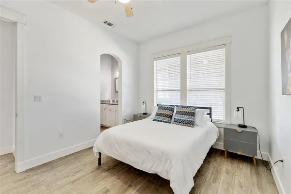 a bedroom with a bed and wooden floor