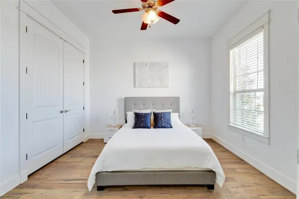 a spacious bedroom with a bed and window