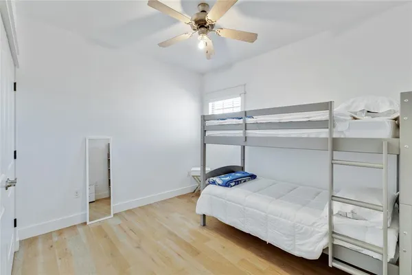a bedroom with a bed and a ceiling fan