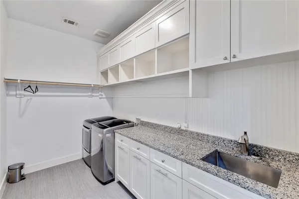 a kitchen with stainless steel appliances granite countertop a sink and cabinets
