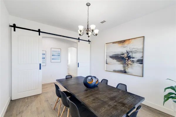 a view of a dining room with furniture wooden floor and a chandelier
