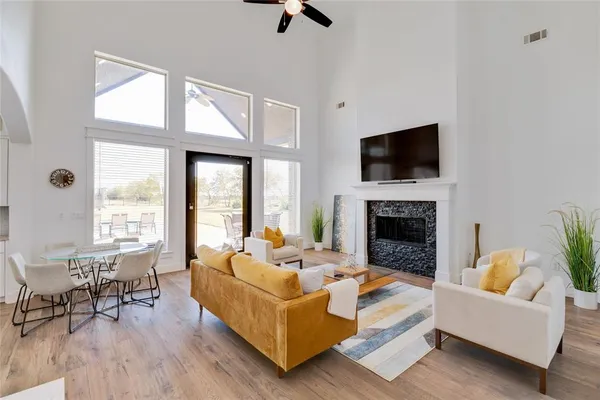 a living room with furniture a fireplace and a flat screen tv