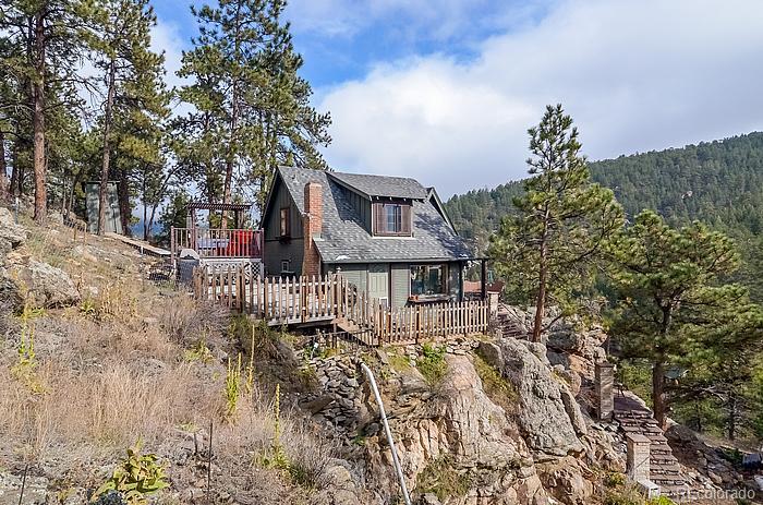 3085 High Road Evergreen, CO 80439 - Photo 1 of 1 a view of a house with a yard