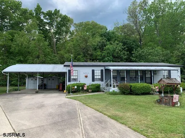 a view of a house with a patio and garden