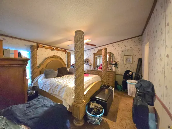 a bedroom with bed and wooden floor