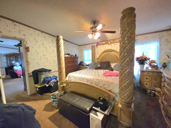 a bedroom with a bed and a chandelier