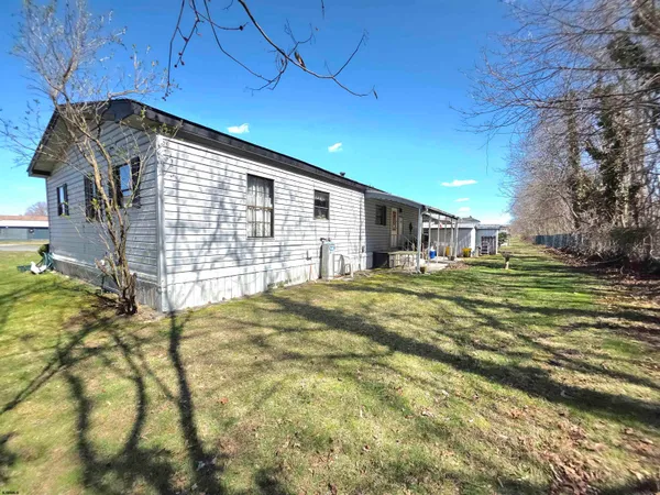 a view of a house with backyard and trees