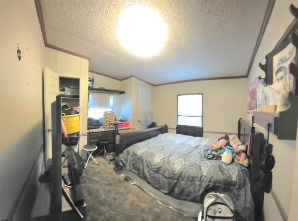 a bedroom with bed and a window