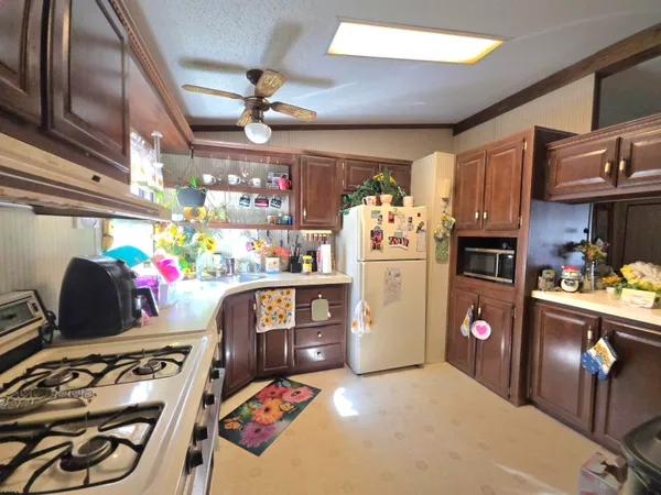 a kitchen area with stainless steel appliances granite countertop a refrigerator and stove