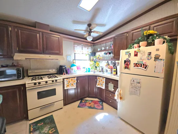 a kitchen with stainless steel appliances a stove a refrigerator and a refrigerator