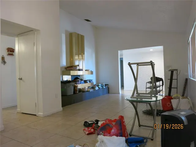 a living room with furniture and a mirror