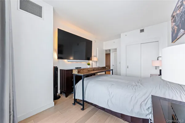 a bedroom with a bed and a flat screen tv