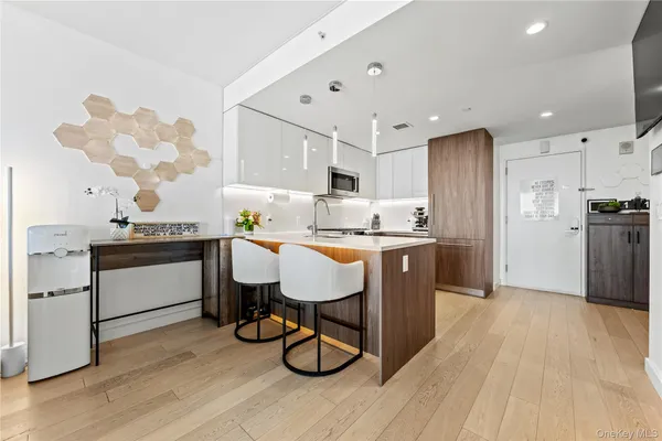 a kitchen with a sink appliances and cabinets