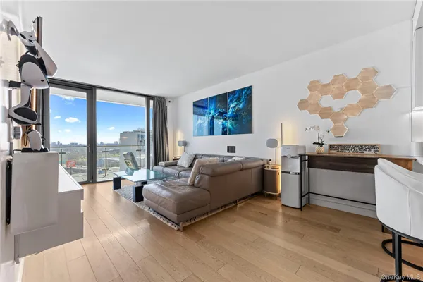 a living room with furniture fireplace and large windows