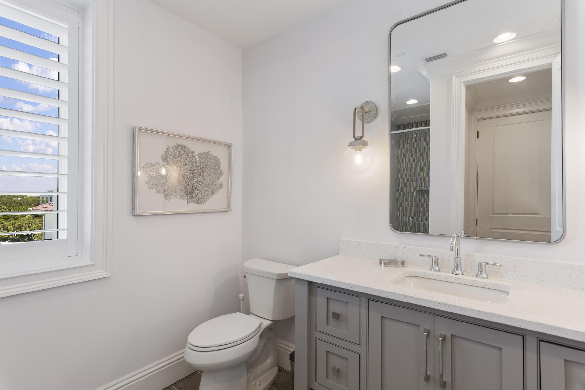 26 Azzurro Way Santa Rosa Beach, FL 32459 - Photo 74 of 78 a bathroom with a toilet a sink a mirror and a shower