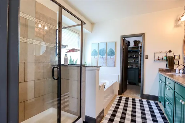 a bathroom with a glass shower door