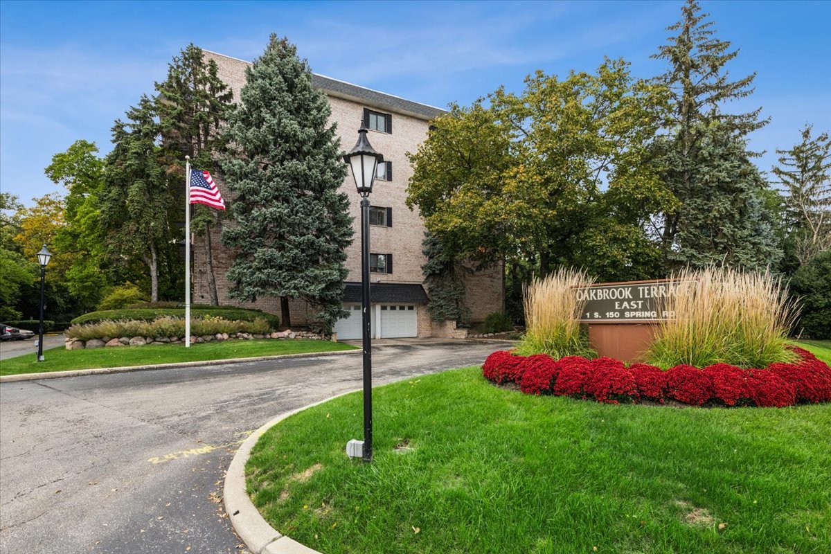 1-s150 Spring Road, Unit 4L Oak Brook, IL 60181 - Photo 1 of 18 a front view of a house with a yard and tree