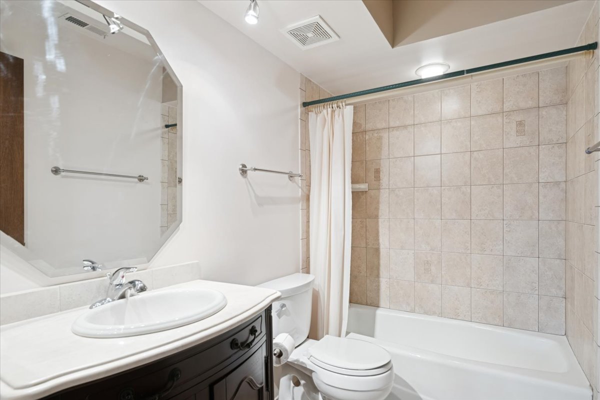 1-s150 Spring Road, Unit 4L Oak Brook, IL 60181 - Photo 16 of 18 a bathroom with a sink a toilet and shower