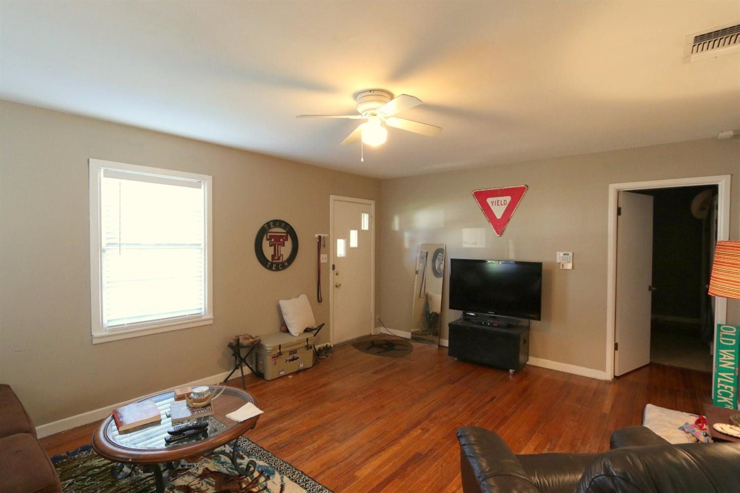 2405 22nd Street Lubbock, TX 79411 - Photo 3 of 10 a living room with furniture a flat screen tv and a window