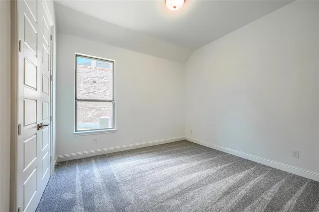 an empty room with fan and windows