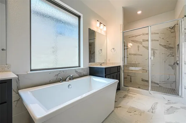 a bathroom with a shower sink and mirror