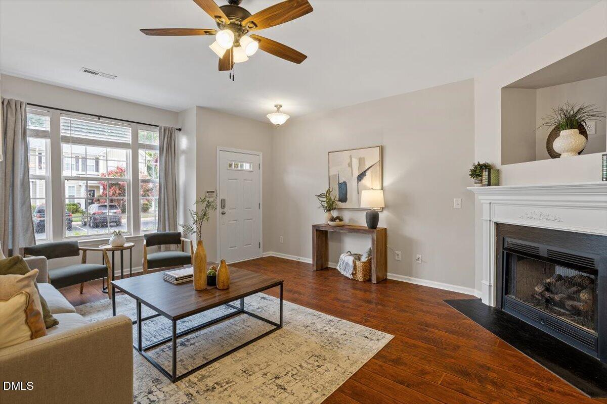 7734 Winners Edge Street Raleigh, NC 27617 - Photo 8 of 37 a living room with furniture and a fireplace