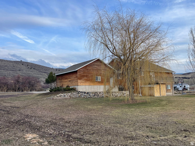 333 Lago Liberty Road Grace, ID 83241 - Photo 8 of 35 View of property exterior featuring a mountain view and a lawn