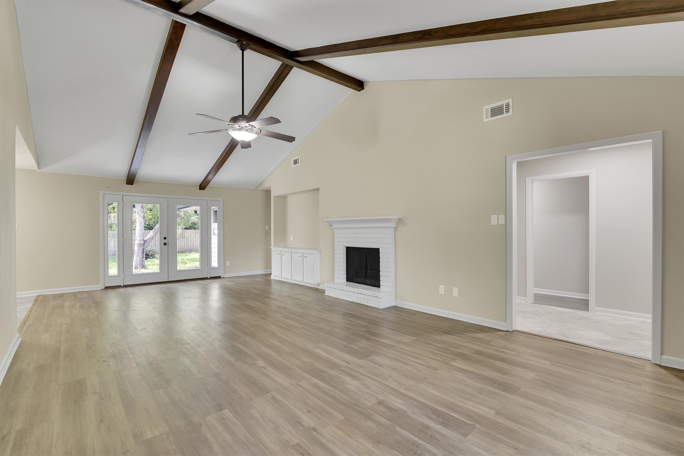 345 Maple Lane Conroe, TX 77304 - Photo 1 of 35 a view of an empty room with a fireplace and a window