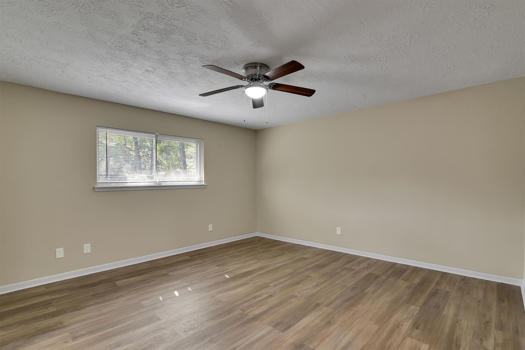 345 Maple Lane Conroe, TX 77304 - Photo 14 of 35 a view of a room with wooden floor and ceiling fan