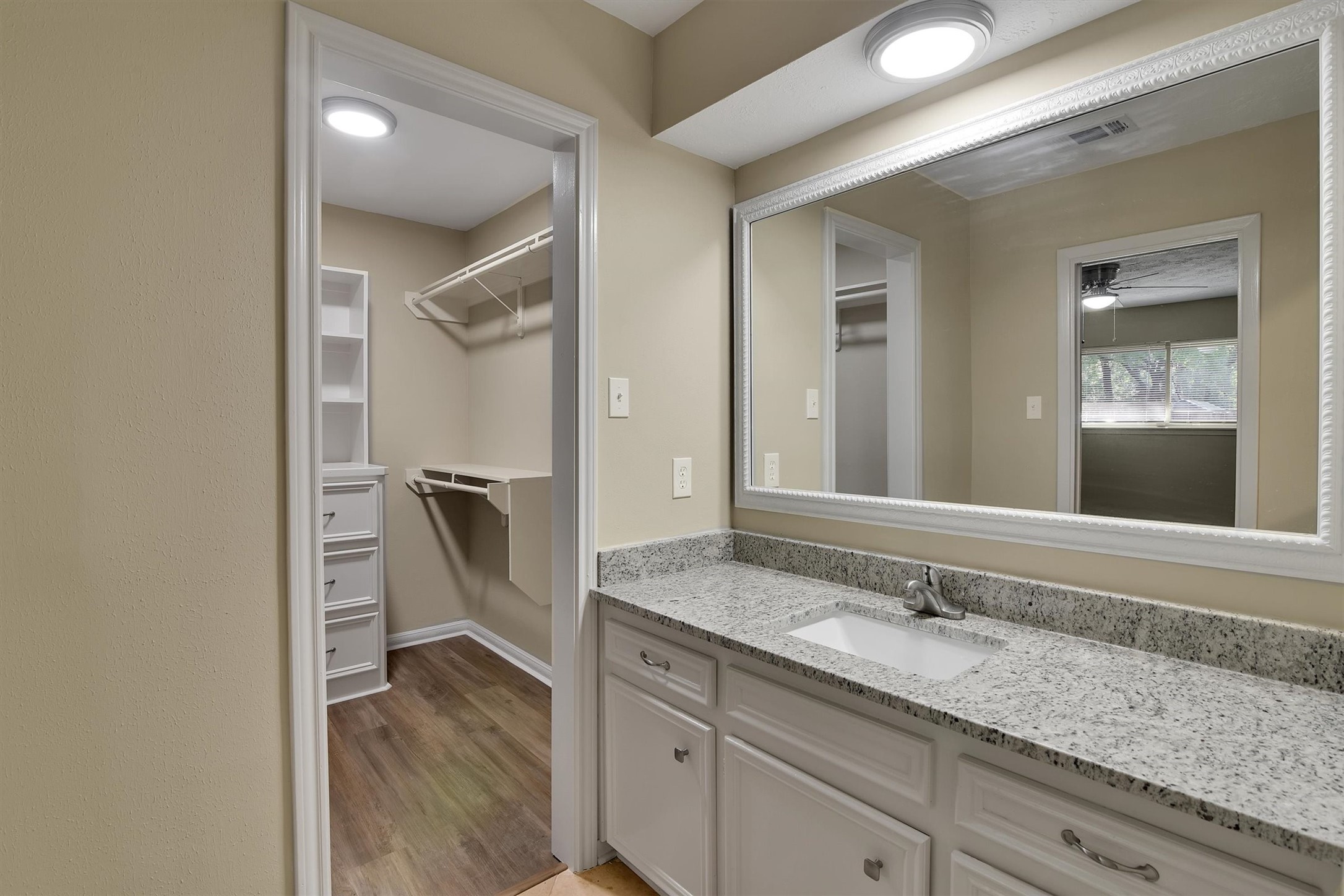 345 Maple Lane Conroe, TX 77304 - Photo 16 of 35 a bathroom with a granite countertop sink and a mirror