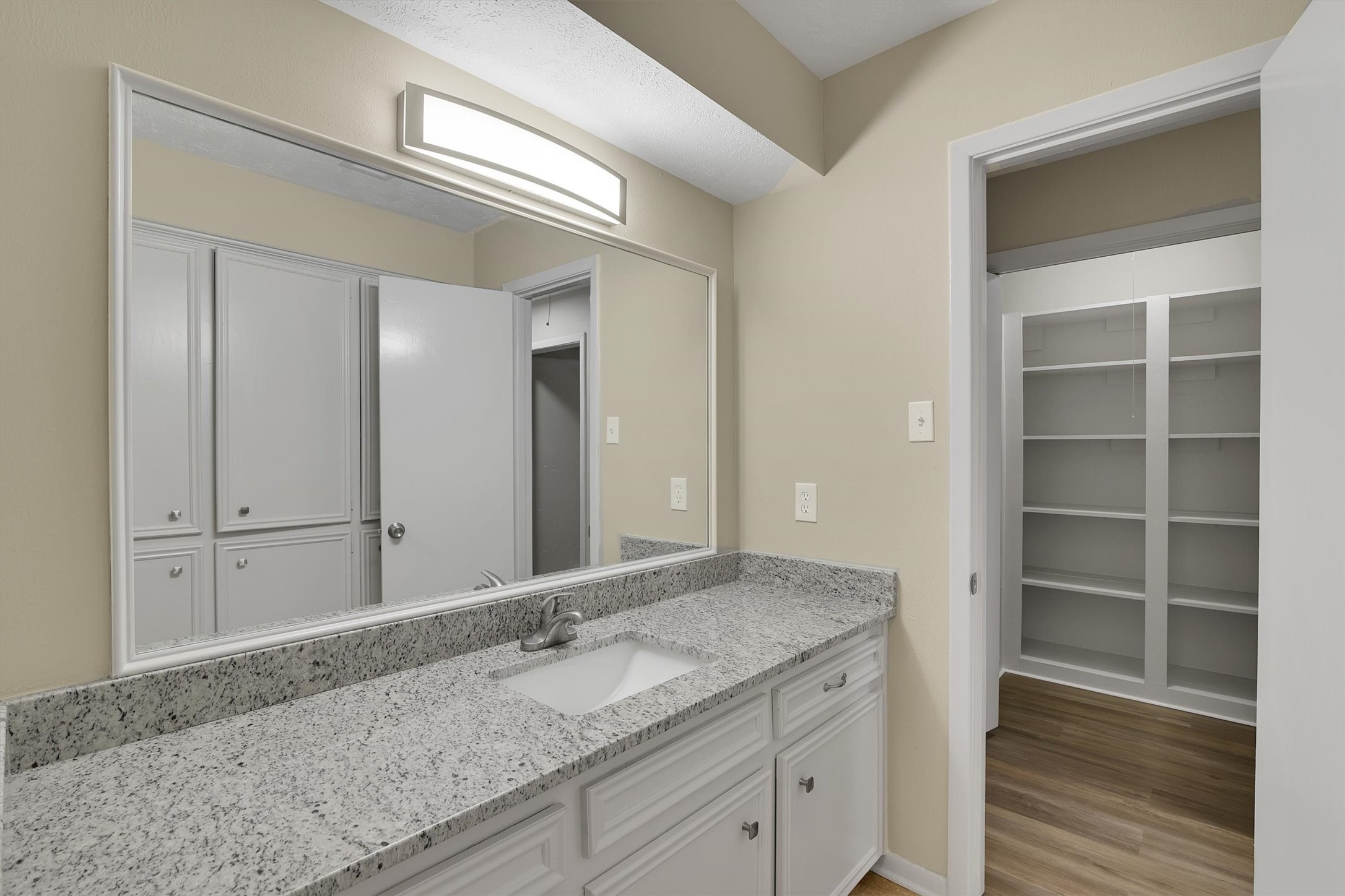 345 Maple Lane Conroe, TX 77304 - Photo 20 of 35 a bathroom with a granite countertop sink and a mirror