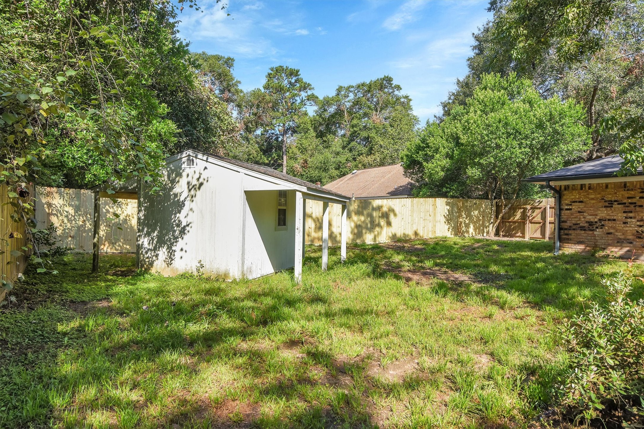 345 Maple Lane Conroe, TX 77304 - Photo 33 of 35 a view of a house with a yard