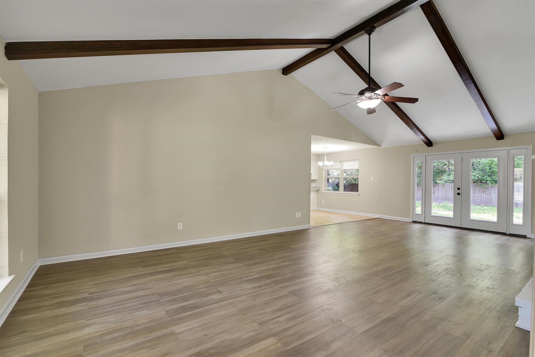 345 Maple Lane Conroe, TX 77304 - Photo 5 of 35 a view of an empty room with wooden floor and a window