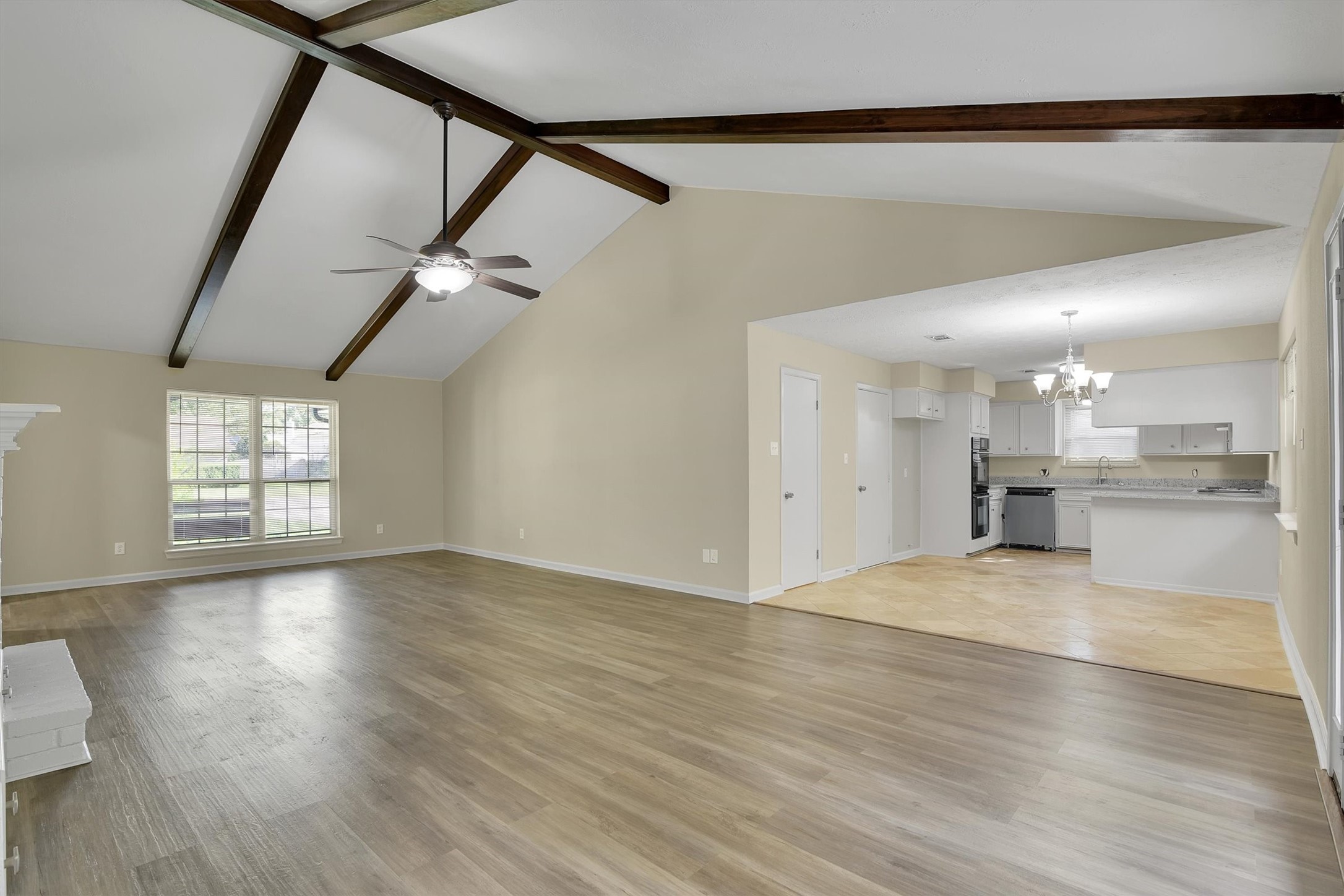 345 Maple Lane Conroe, TX 77304 - Photo 7 of 35 an empty room with wooden floor cabinet and windows
