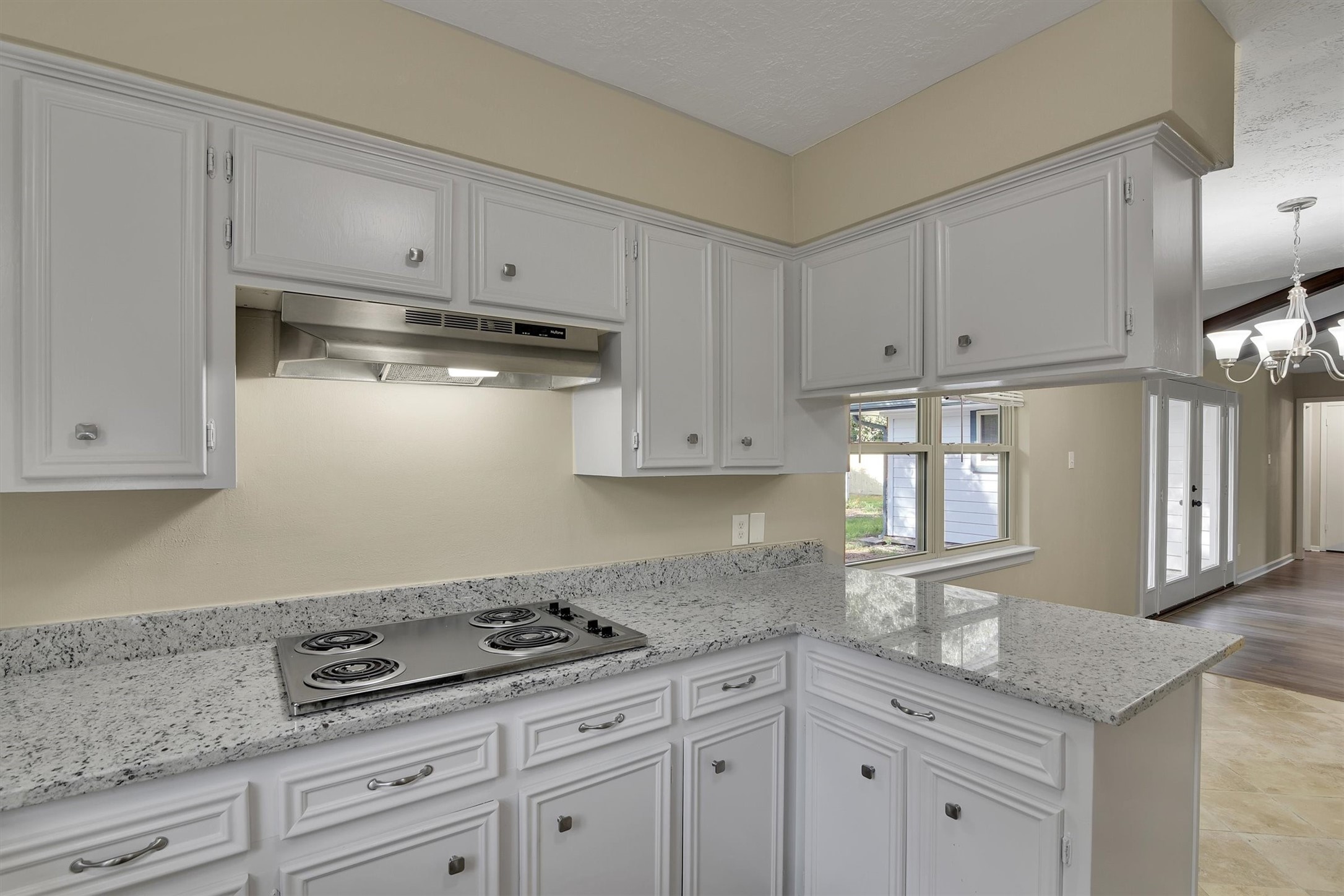 345 Maple Lane Conroe, TX 77304 - Photo 9 of 35 a kitchen with granite countertop a stove a sink and dishwasher wooden cabinets with granite countertops