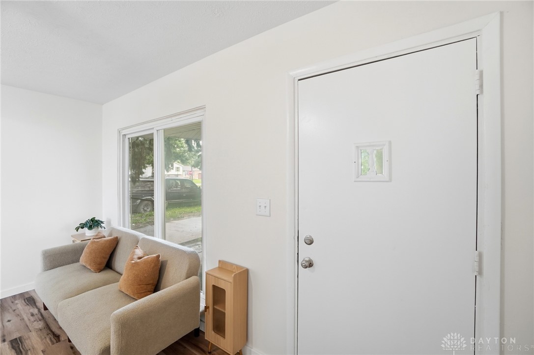 1923 Portage Path Springfield, OH 45506 - Photo 6 of 40 A welcoming entry, complete with rich hardwood flooring, ushers guests into a comfortable living area.