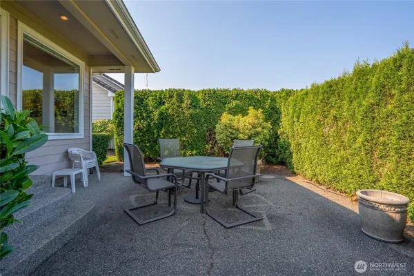 a view of a patio with chairs and table
