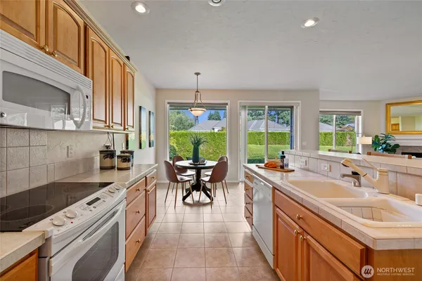 a kitchen with a sink stove and cabinets