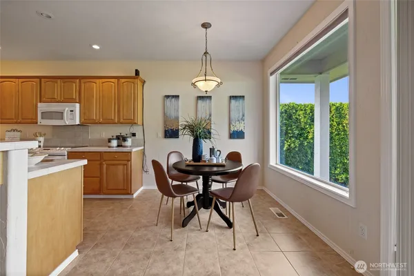 a kitchen with a table and chairs in it