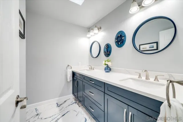 a bathroom with a double vanity sink and a mirror