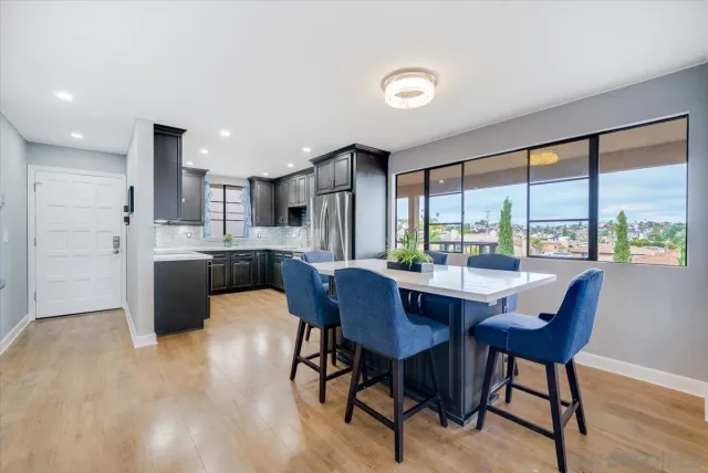a view of a dining room with furniture and a window